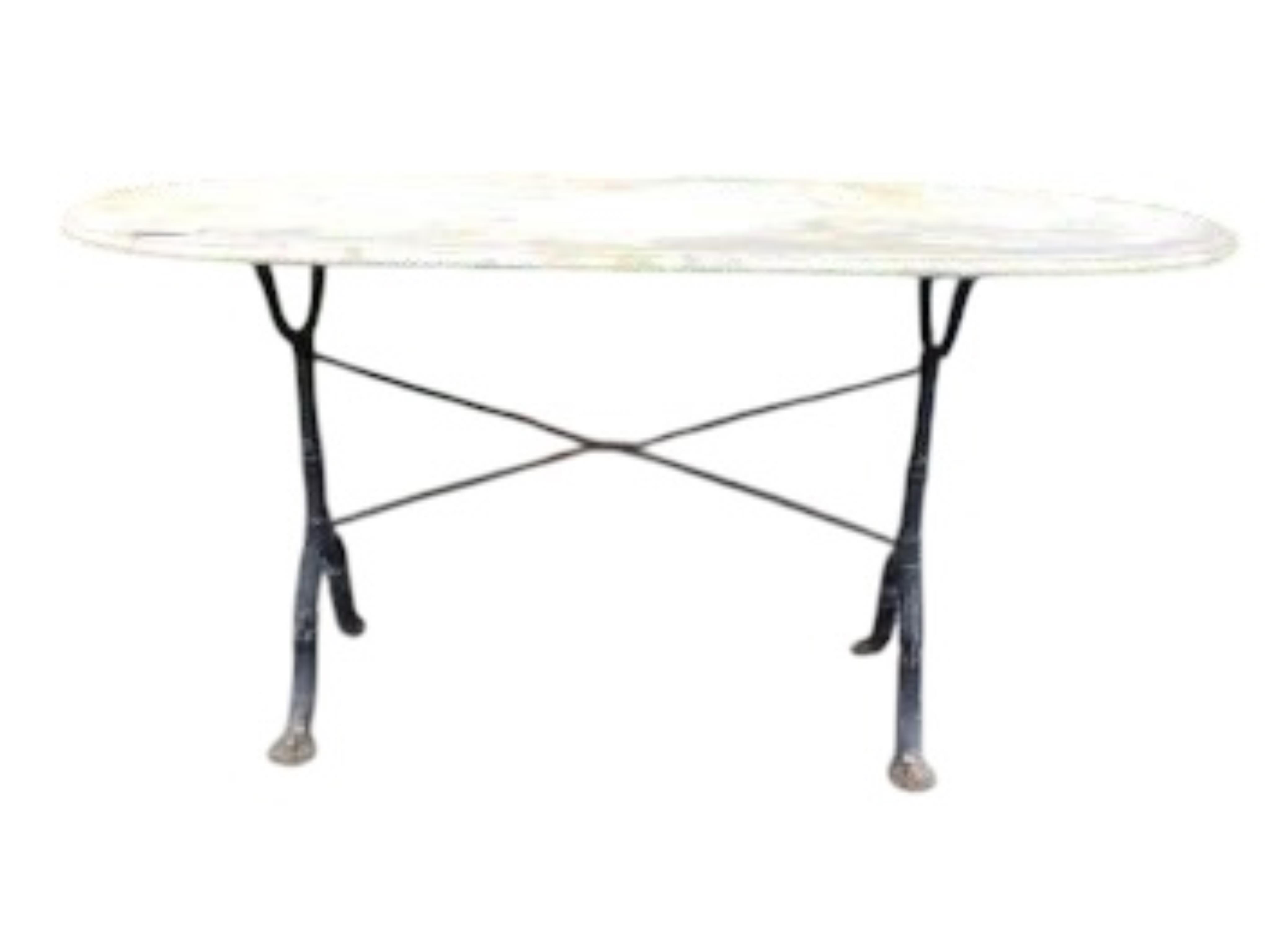 An oval reconstituted marble and wrought iron garden table, width 135cm, depth 69cm, height 70cm